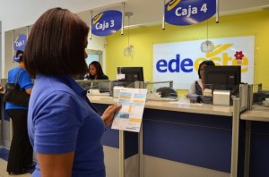 Una señora lee una factura de EDE Este con formato más pequeño.
